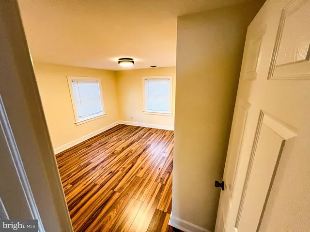 a view of walk in closet with wooden floor