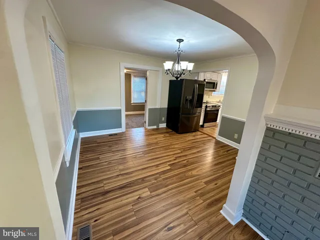 wooden floor in an empty room with a mirror