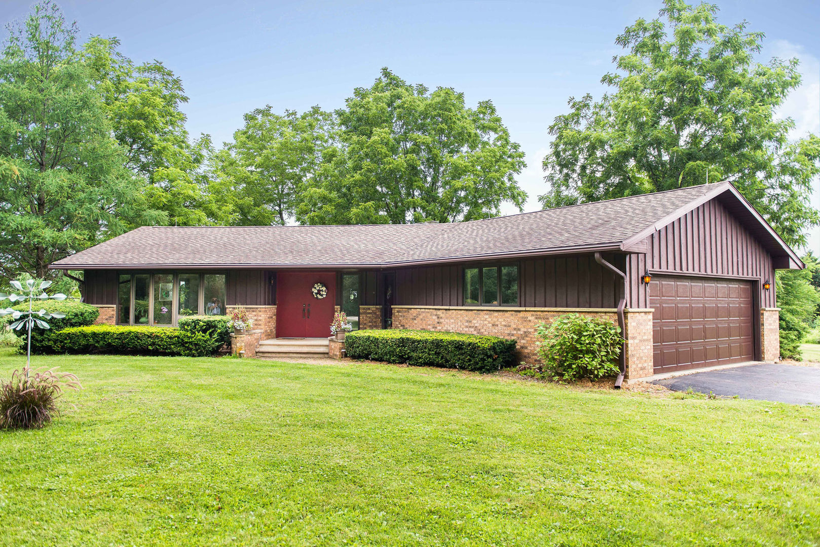 16045 Whipple Road Sycamore, IL 60178 - Photo 2 of 60 a view of a yard in front of a house with plants and large tree