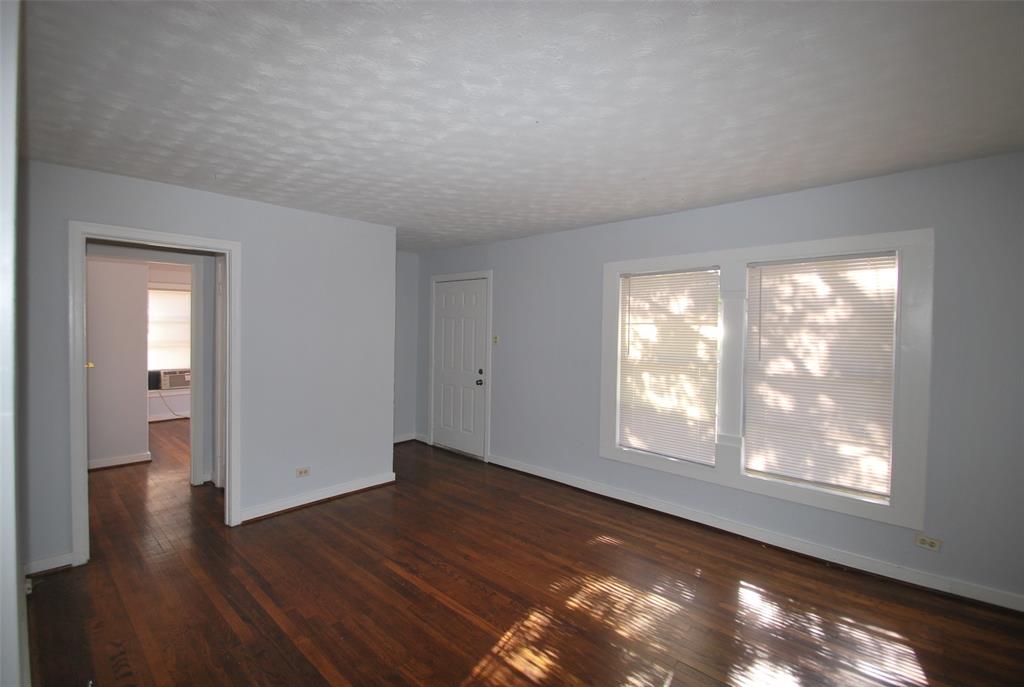 6918 Lockheed Avenue Dallas, TX 75209 - Photo 2 of 9 a view of an empty room with wooden floor and a window