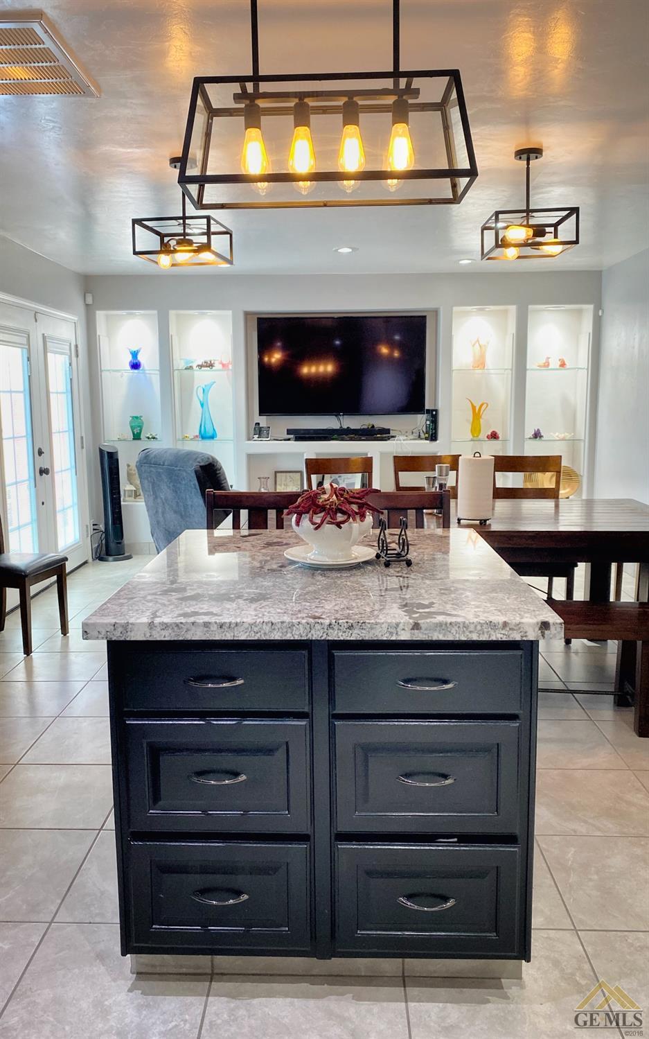 Undisclosed Address Wasco, CA 93280 - Photo 14 of 40 a kitchen with a stove and a flat screen tv
