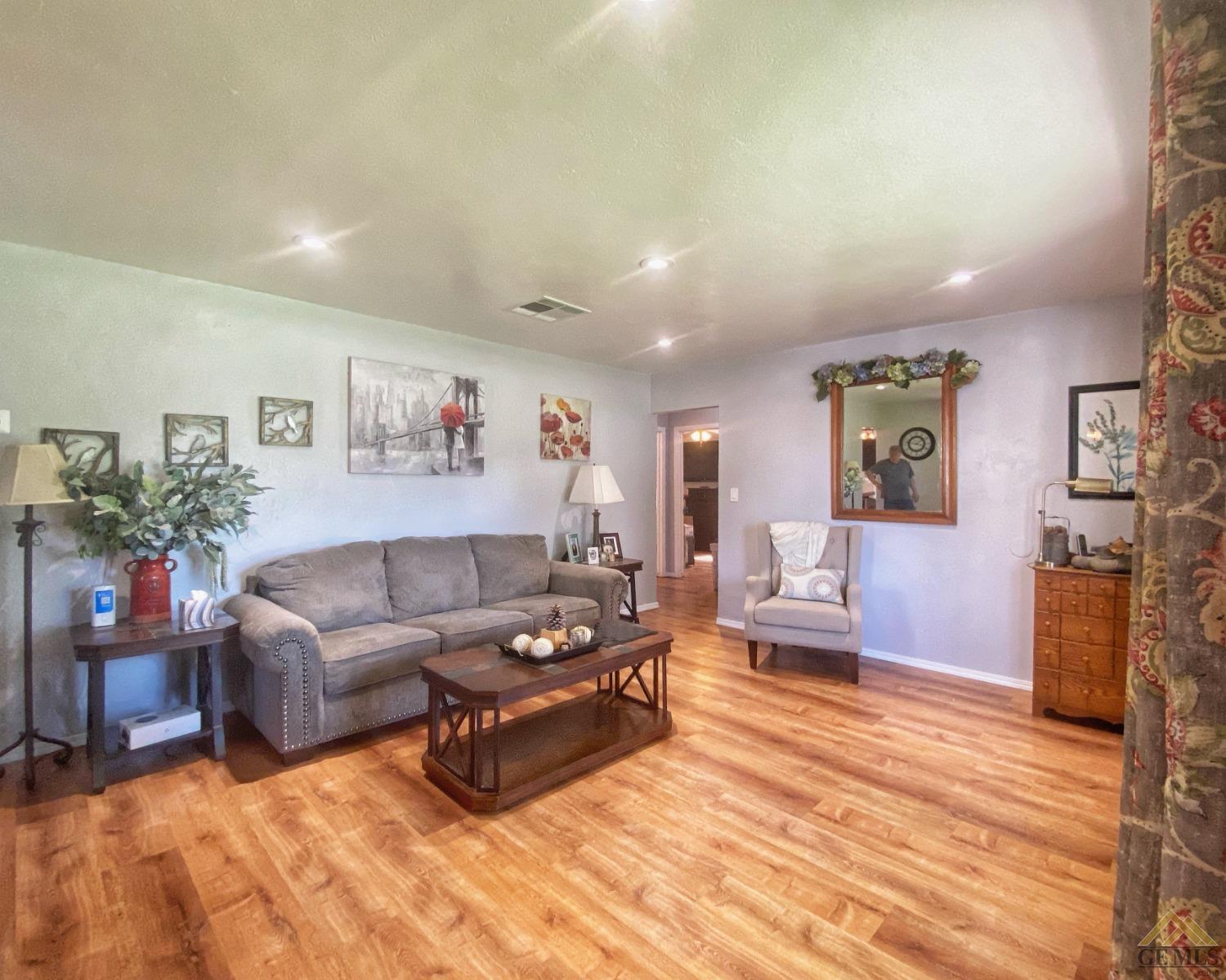Undisclosed Address Wasco, CA 93280 - Photo 20 of 40 a living room with furniture and wooden floor