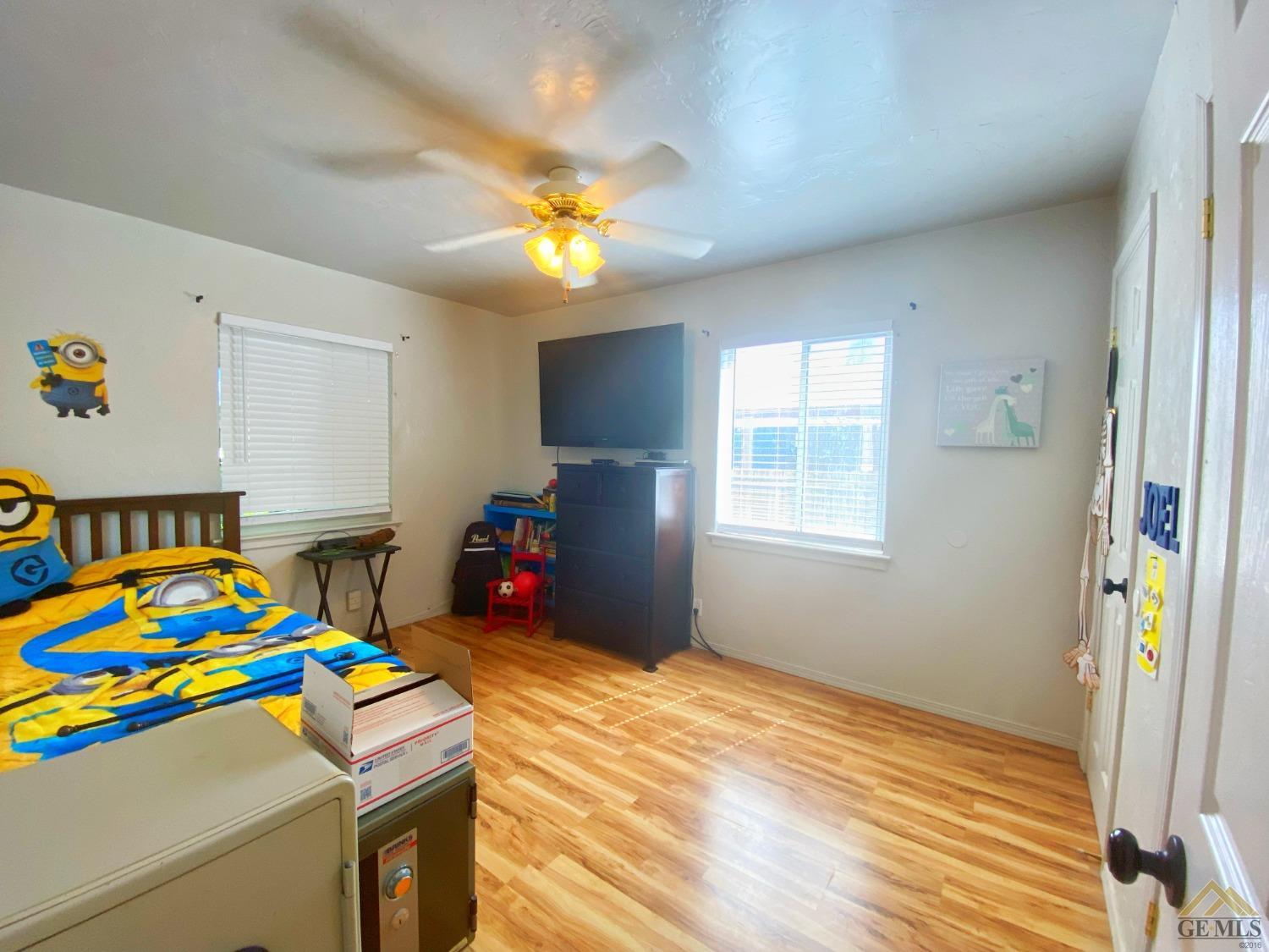 Undisclosed Address Wasco, CA 93280 - Photo 32 of 40 a bedroom with a bed and a chandelier