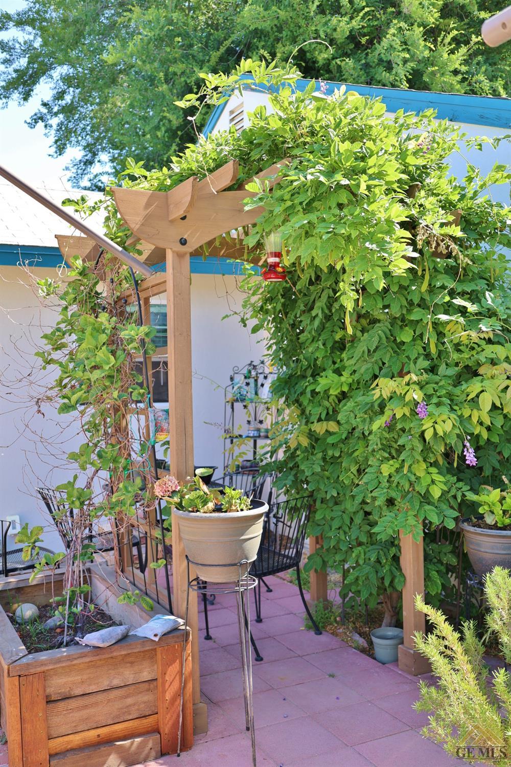 Undisclosed Address Wasco, CA 93280 - Photo 7 of 40 a view of a chairs and table in a backyard