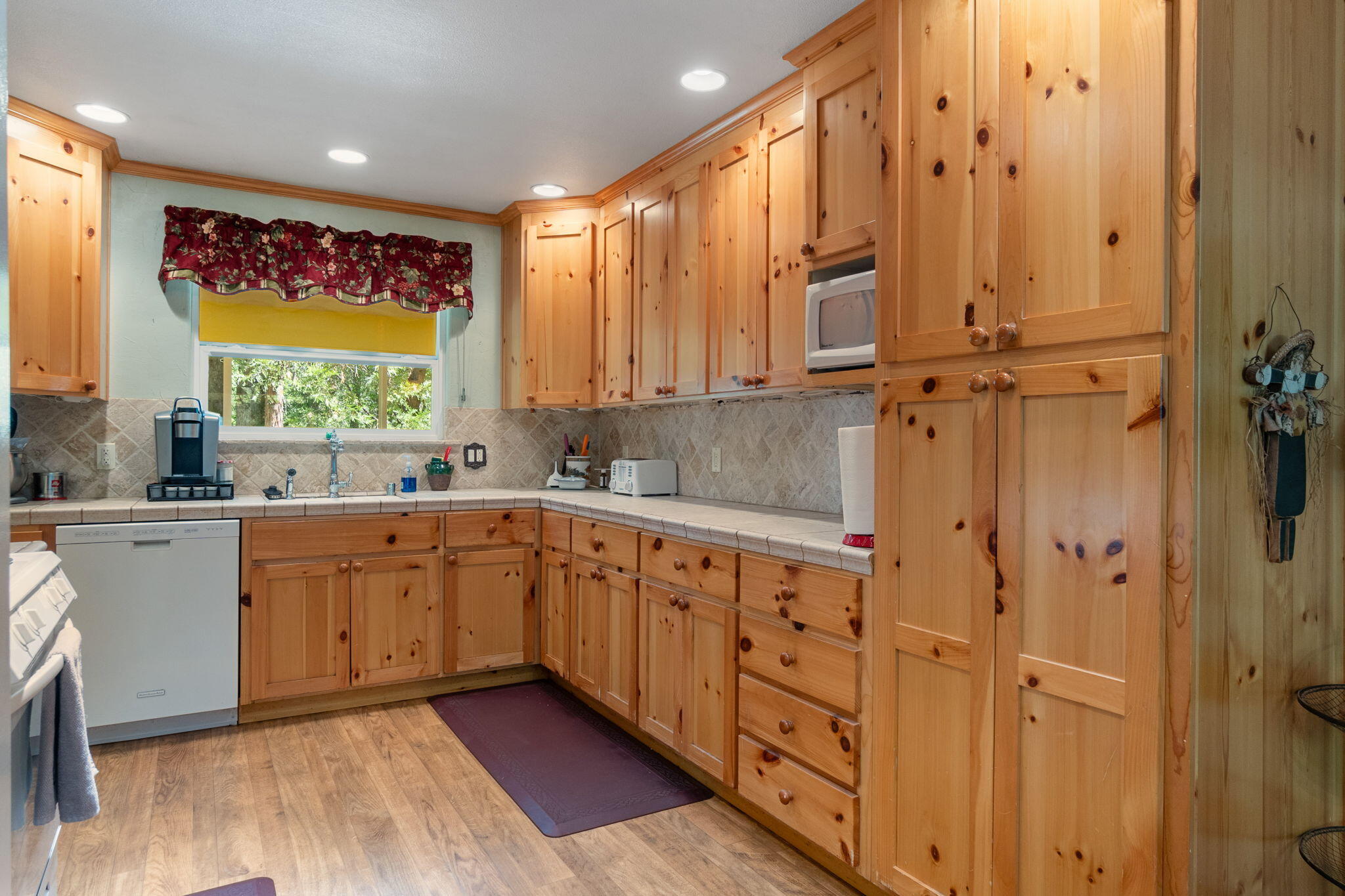 30303 Oak Run To Fern Road Whitmore, CA 96096 - Photo 8 of 75 a large kitchen with stainless steel appliances a large window and wooden floor