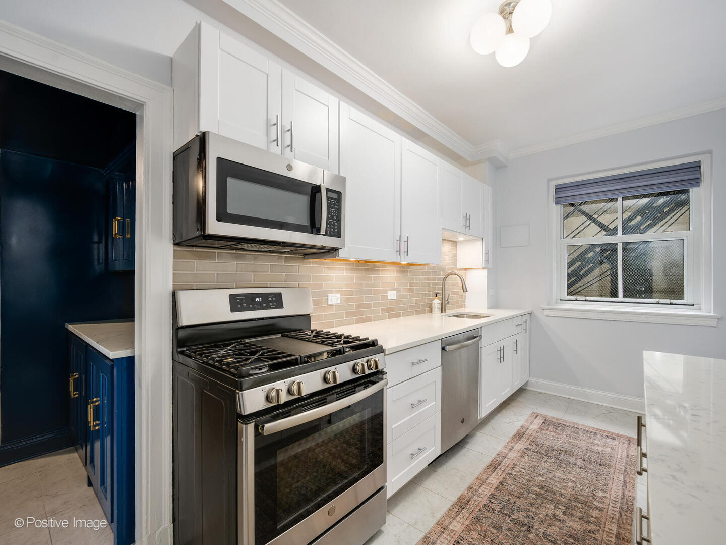 3530 North Lake Shore Drive, Unit 11B Chicago, IL 60657 - Photo 14 of 24 a kitchen with stainless steel appliances granite countertop a stove a microwave and a refrigerator
