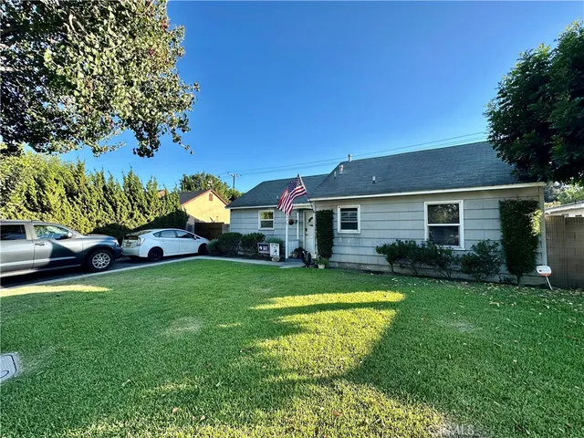 a view of a house with a backyard and a patio