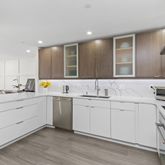 a kitchen with granite countertop a sink stainless steel appliances and cabinets