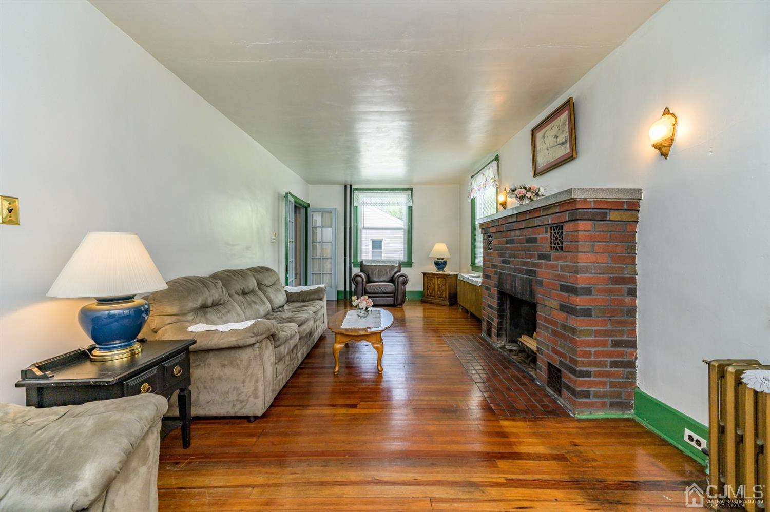 1237 Lower Ferry Road Ewing, NJ 08618 - Photo 13 of 42 a living room with furniture and a fireplace