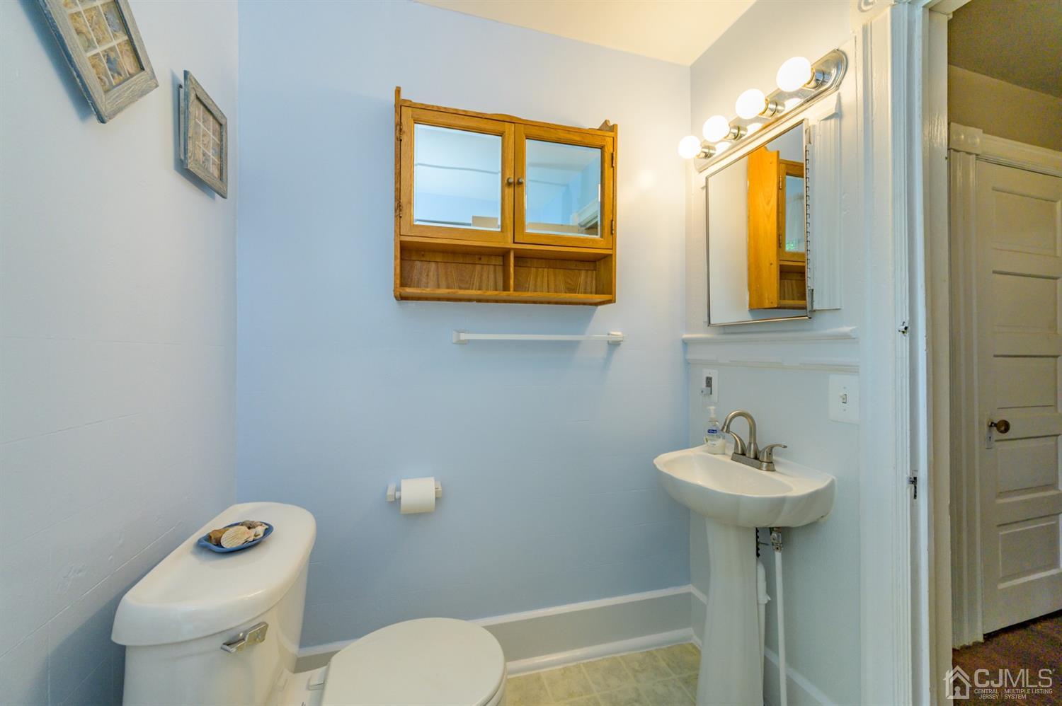 1237 Lower Ferry Road Ewing, NJ 08618 - Photo 18 of 42 a bathroom with a toilet sink and mirror