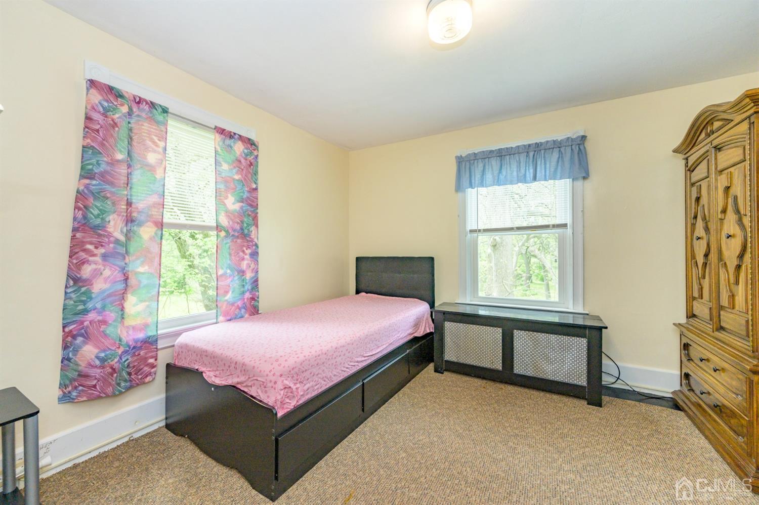 1237 Lower Ferry Road Ewing, NJ 08618 - Photo 20 of 42 a bedroom with a bed and a window