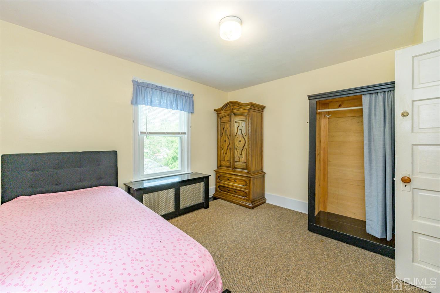 1237 Lower Ferry Road Ewing, NJ 08618 - Photo 21 of 42 a bedroom with a bed and cabinets