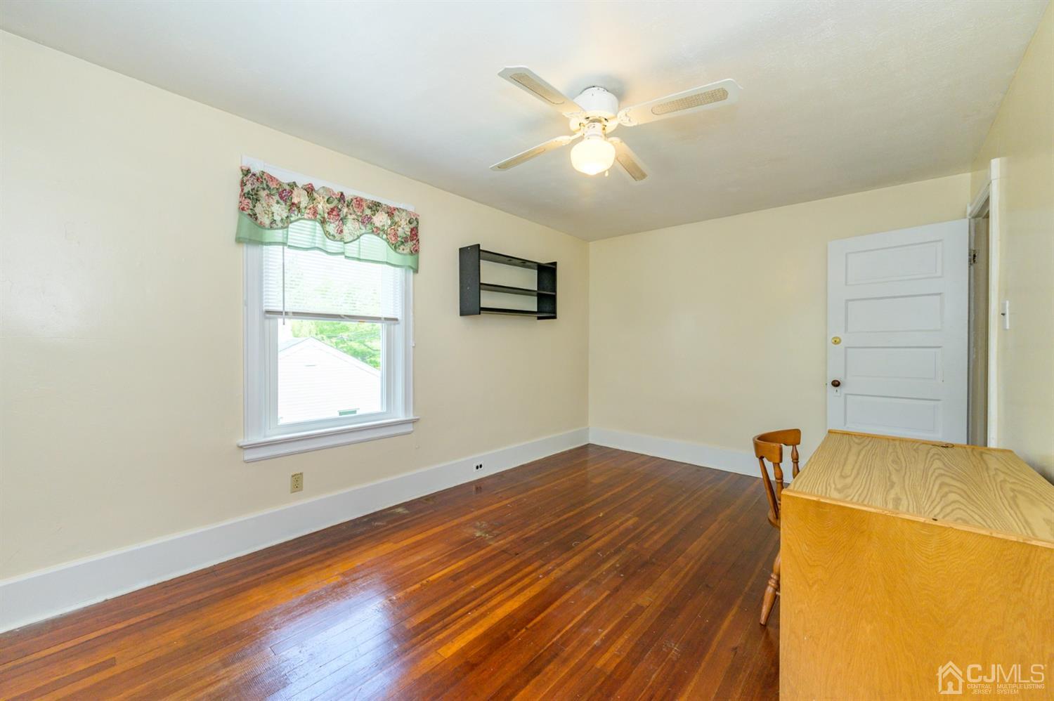 1237 Lower Ferry Road Ewing, NJ 08618 - Photo 23 of 42 a view of a livingroom with wooden floor and a ceiling fan