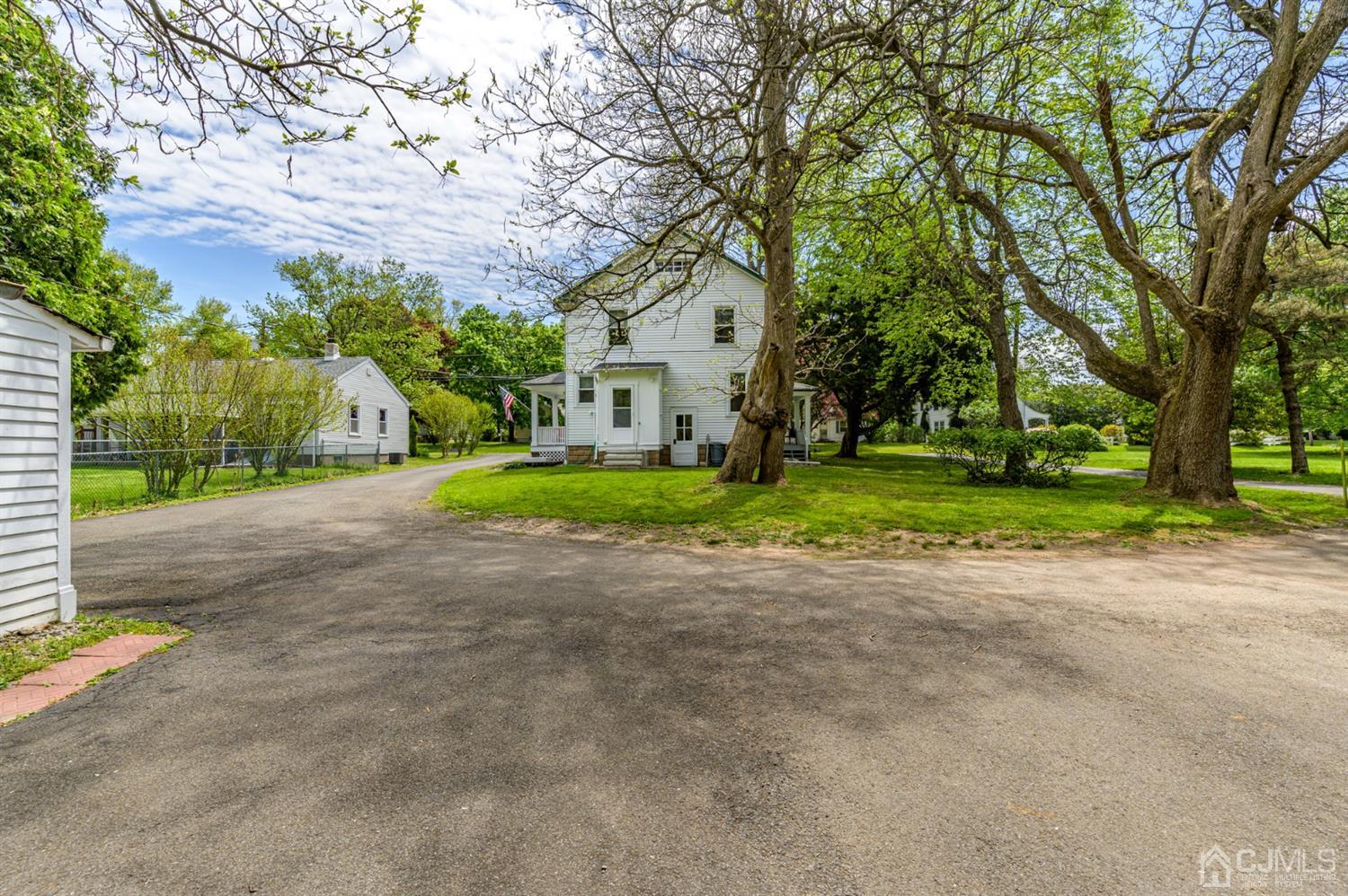 1237 Lower Ferry Road Ewing, NJ 08618 - Photo 30 of 42 a view of a house with a big yard and large trees