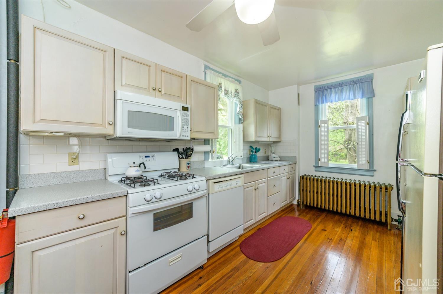 1237 Lower Ferry Road Ewing, NJ 08618 - Photo 7 of 42 a kitchen with stainless steel appliances granite countertop a sink stove cabinets and wooden floor