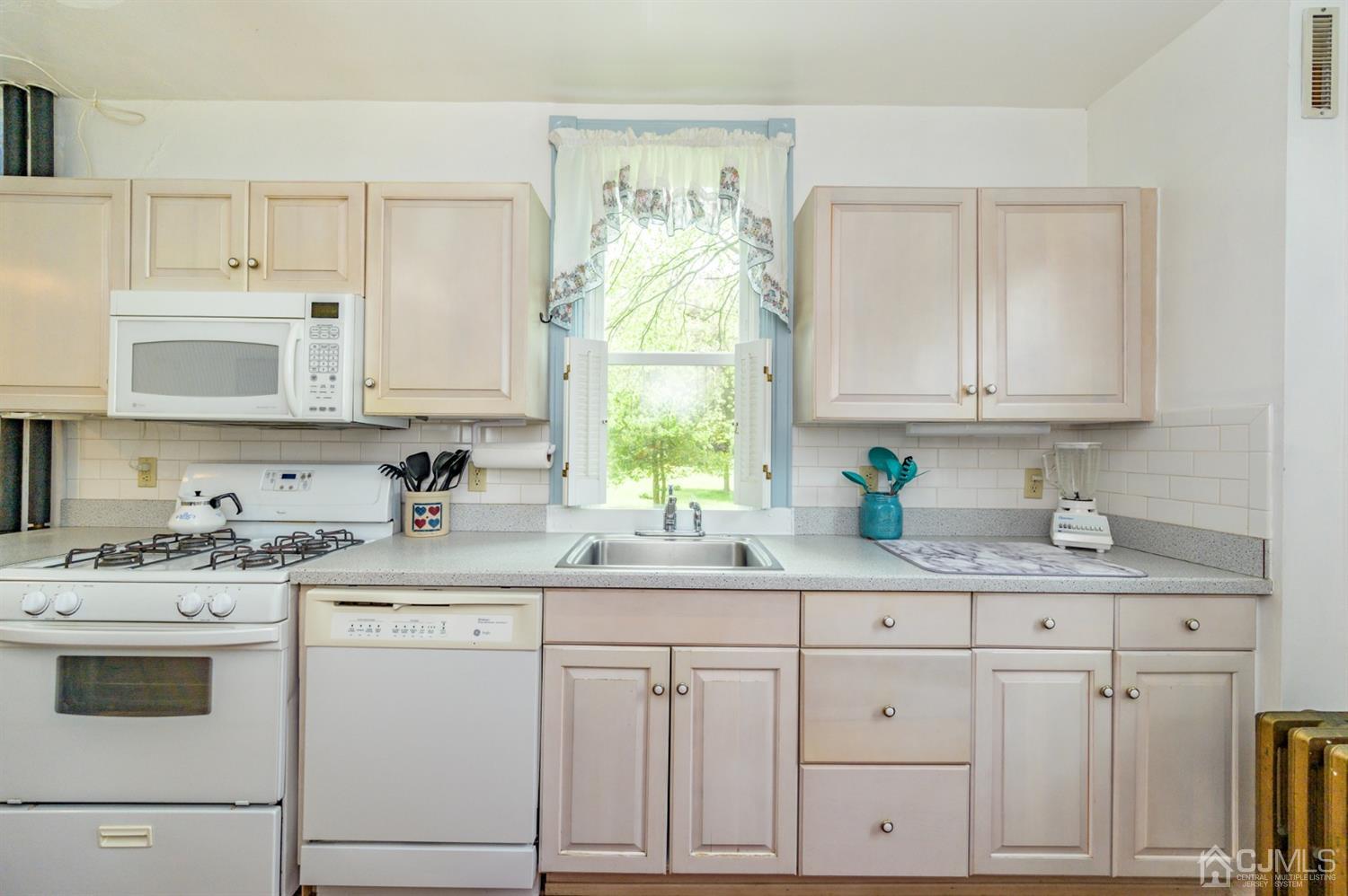 1237 Lower Ferry Road Ewing, NJ 08618 - Photo 8 of 42 a kitchen with white cabinets and white appliances