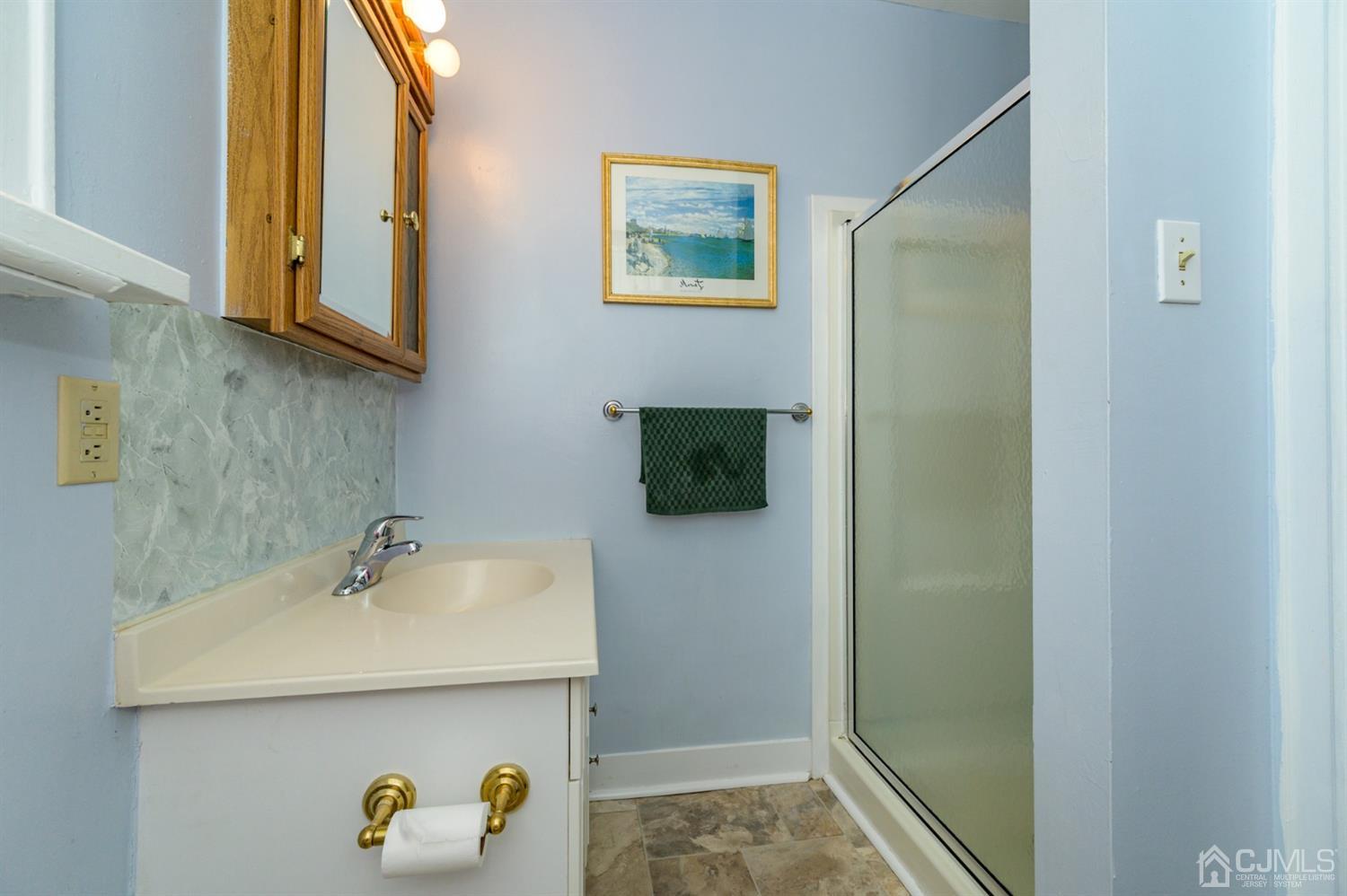 1237 Lower Ferry Road Ewing, NJ 08618 - Photo 10 of 42 a bathroom with a sink and a mirror