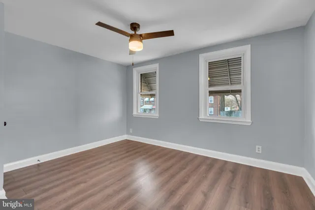 a view of a livingroom with wooden floor and a window