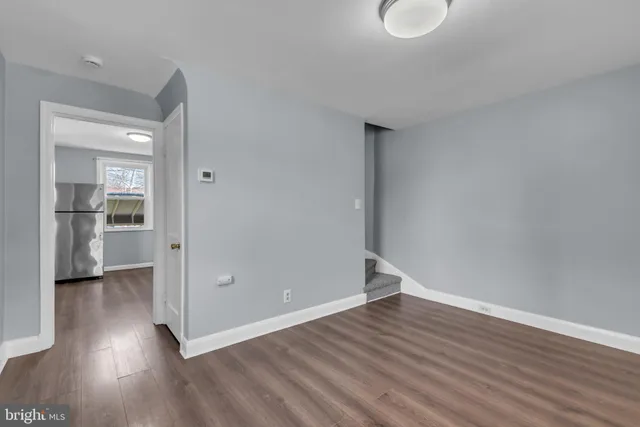 a view of a room with wooden floor and a window