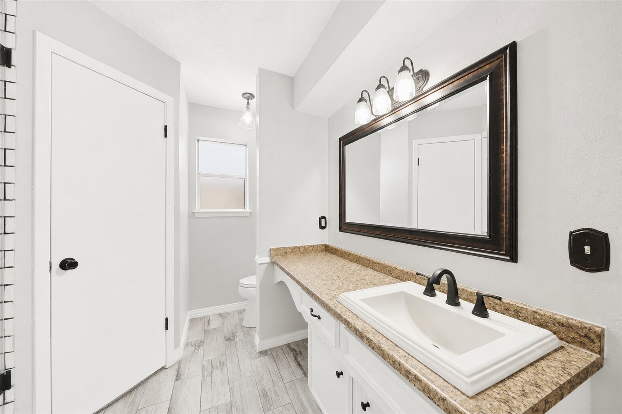 24015 Spring Mill Lane Spring, TX 77373 - Photo 4 of 49 Updated bathroom showcases modern finishes and a spacious vanity.