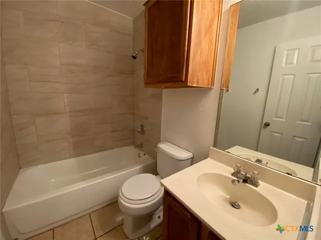 a bathroom with a sink a toilet and bathtub