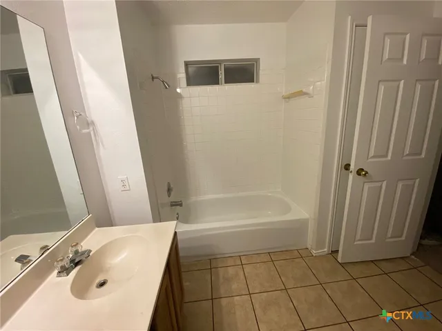 a bathroom with a sink a toilet and a tub