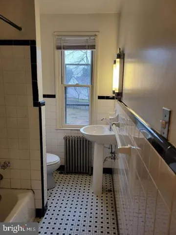 a bathroom with a sink a toilet and a shower