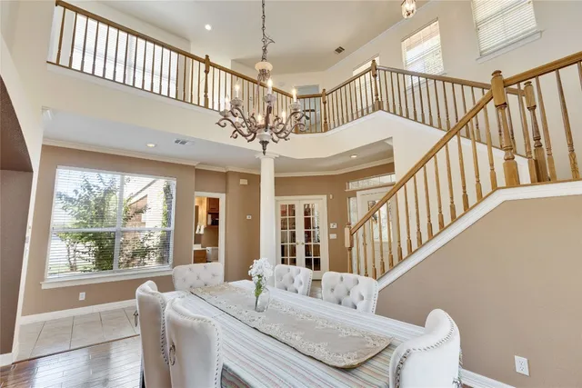 a view of an entryway wooden floor and chandelier