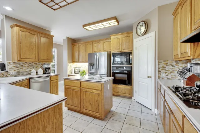 a kitchen with a stove a sink and a refrigerator