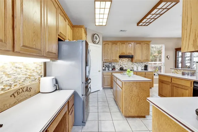 a kitchen with refrigerator and window