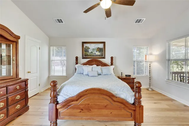 a bedroom with a bed and wooden floor