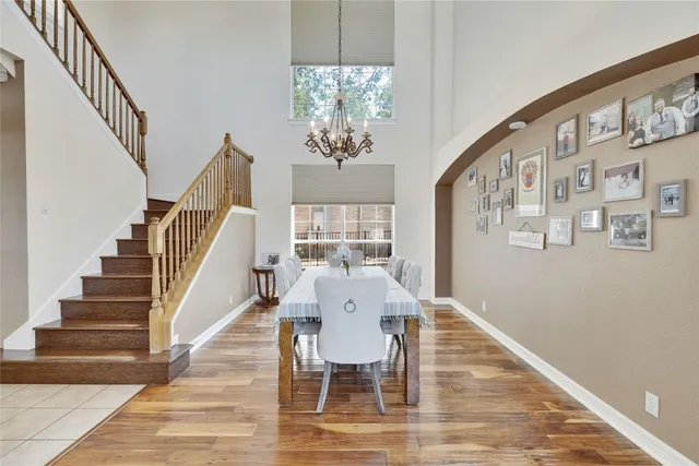 a view of a dining room with furniture a chandelier and wooden floor