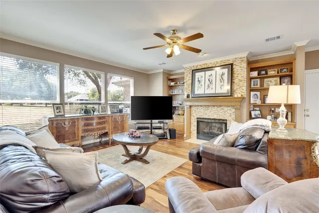 a living room with furniture a flat screen tv and a large window