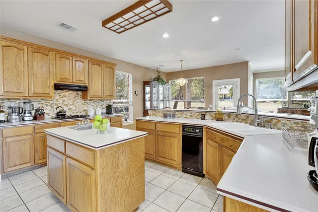 a kitchen with cabinets a sink and appliances