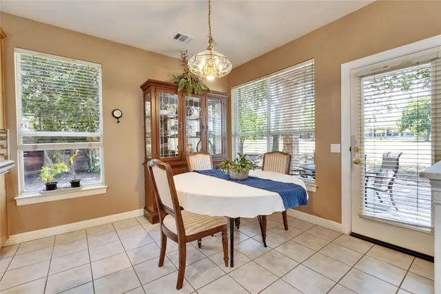 a view of a dining room with furniture large windows and wooden floor