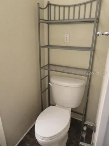 a white toilet sitting next to a sink