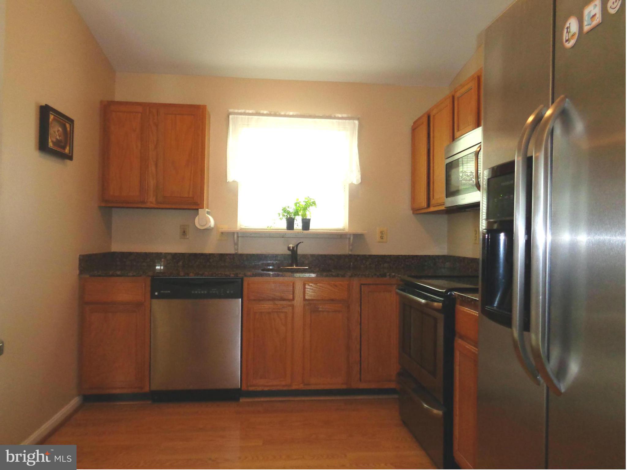 9539 Hallhurst Road Baltimore, MD 21236 - Photo 7 of 24 a kitchen with stainless steel appliances granite countertop a refrigerator and a sink