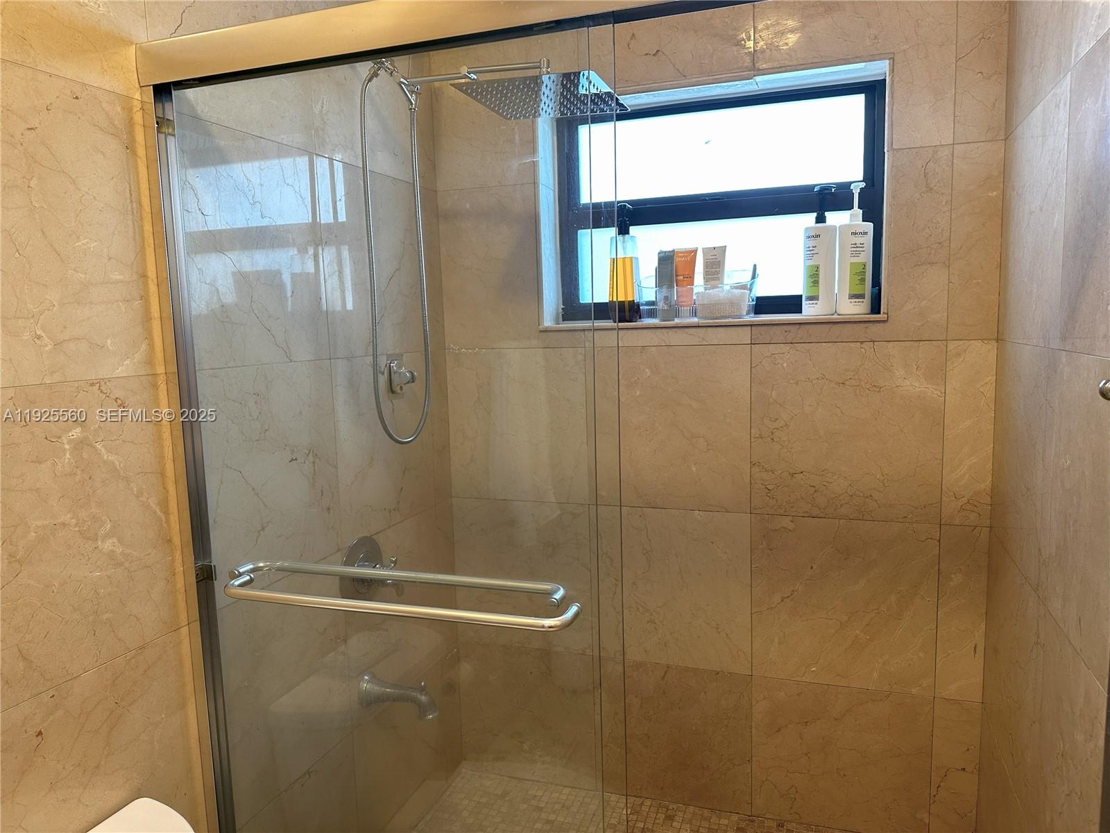 55 Ocean Ln Drive, Unit 4020 Key Biscayne, FL 33149 - Photo 22 of 57 a bathroom with a glass shower door