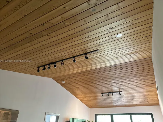 a view of a swimming pool with back yard of a house