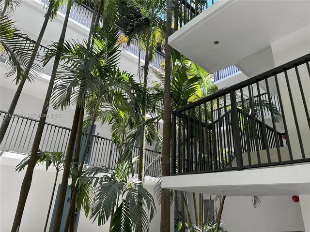 a room with gym equipment and large windows