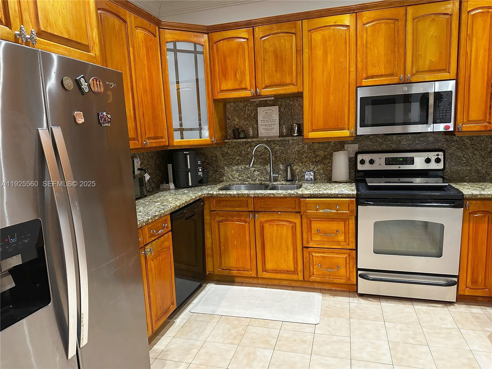 55 Ocean Ln Drive, Unit 4020 Key Biscayne, FL 33149 - Photo 7 of 57 a kitchen with stainless steel appliances granite countertop a refrigerator a stove top oven a sink and dishwasher