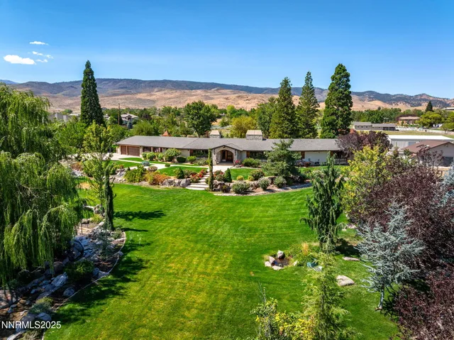 a view of a house with a yard and potted plants