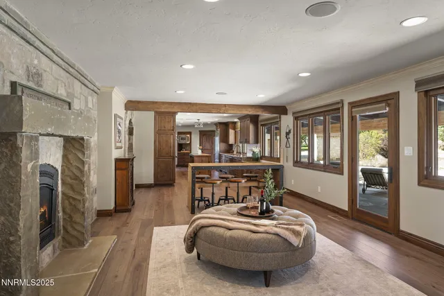 a spacious bedroom with a bed a dresser and a large window
