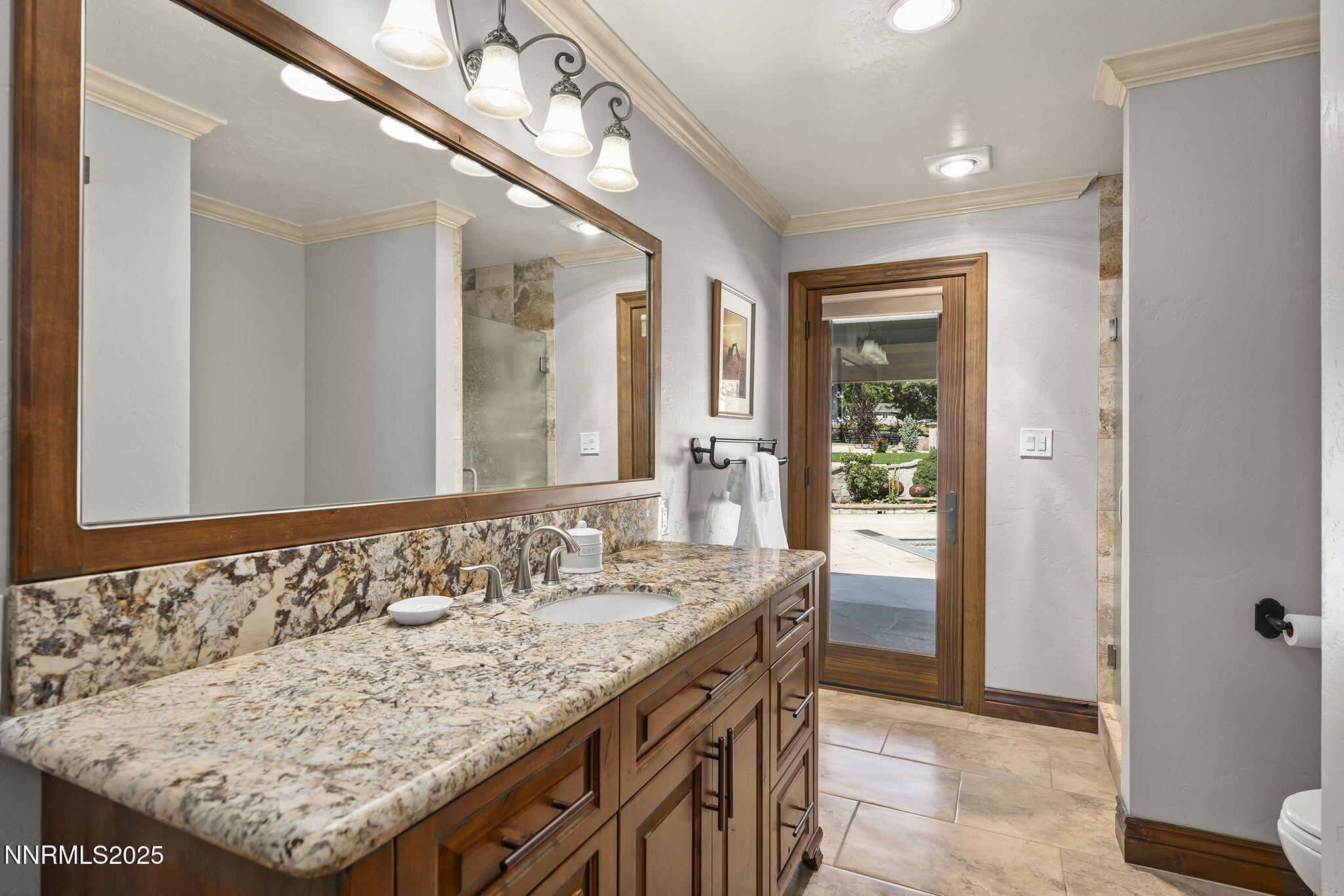 3405 Lone Tree Lane Reno, NV 89511 - Photo 28 of 80 a bathroom with a granite countertop sink and a mirror
