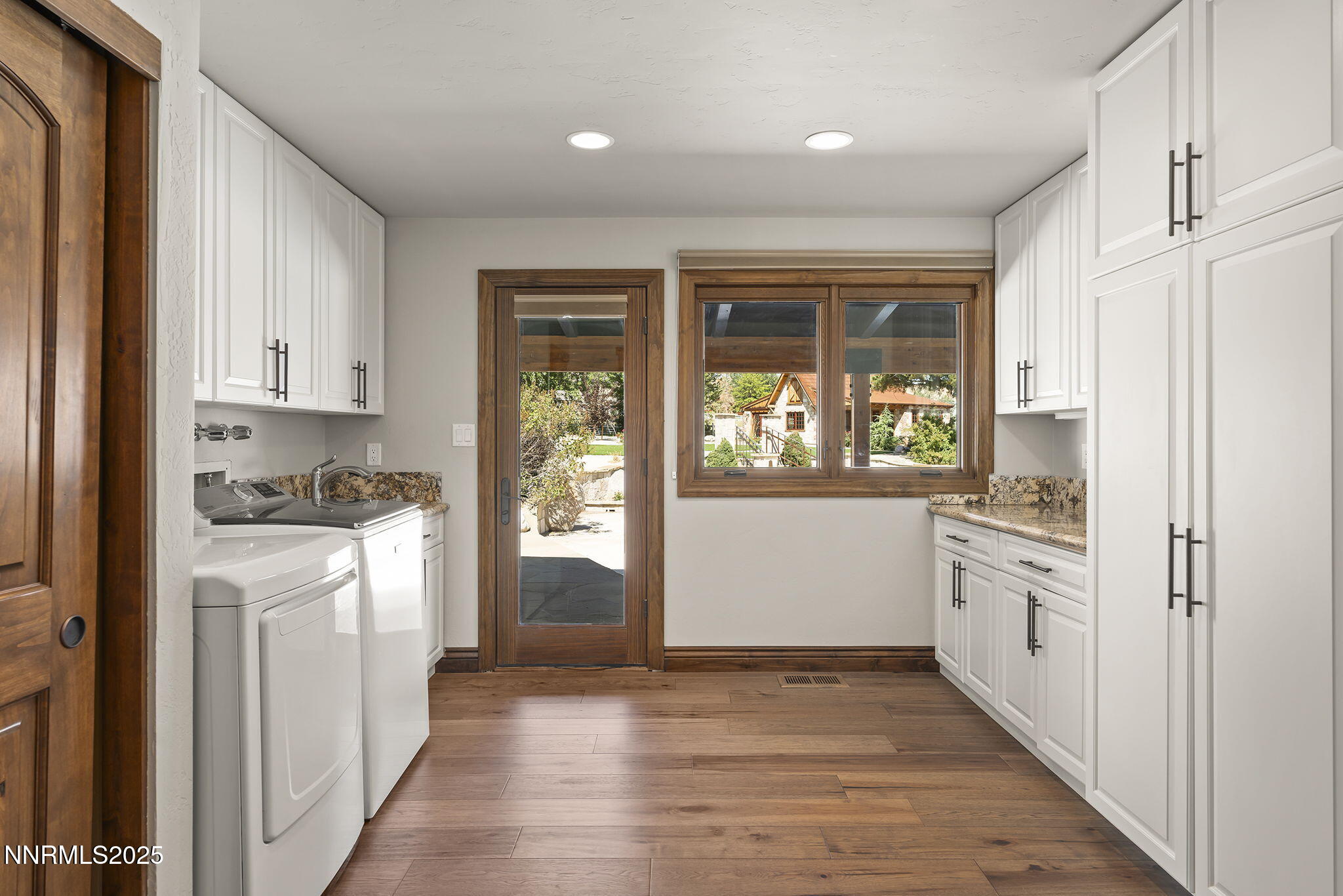 3405 Lone Tree Lane Reno, NV 89511 - Photo 30 of 80 a kitchen with white cabinets and wooden floor