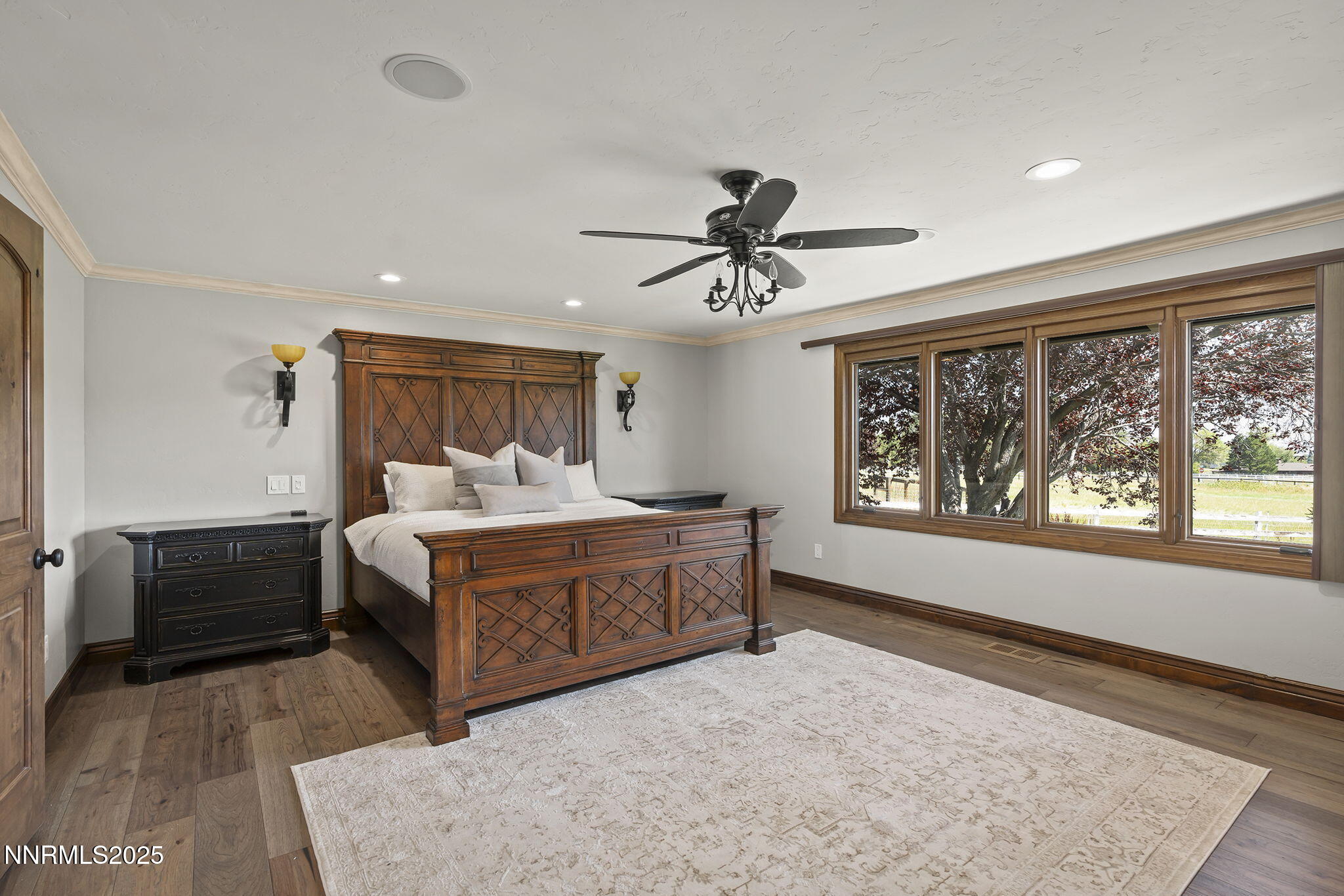 3405 Lone Tree Lane Reno, NV 89511 - Photo 31 of 80 a spacious bedroom with a bed a dresser and a large window