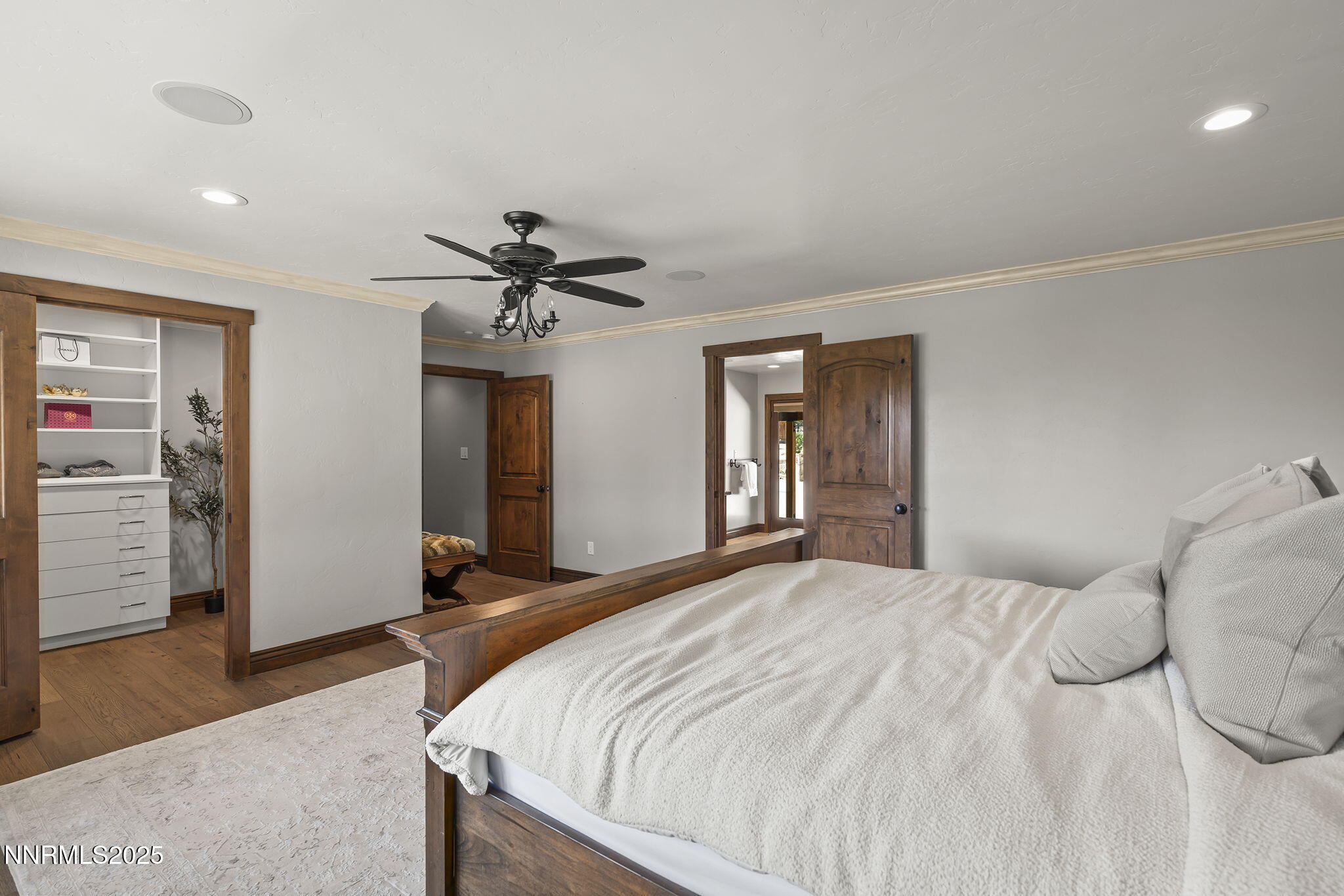 3405 Lone Tree Lane Reno, NV 89511 - Photo 32 of 80 a bedroom with a large bed and a chandelier