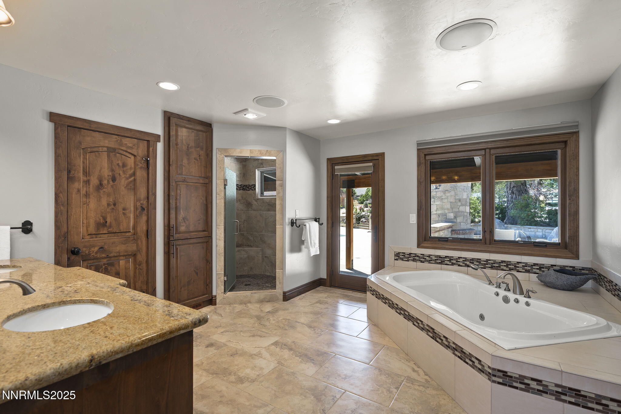 3405 Lone Tree Lane Reno, NV 89511 - Photo 35 of 80 a bathroom with a granite countertop tub sink and mirror