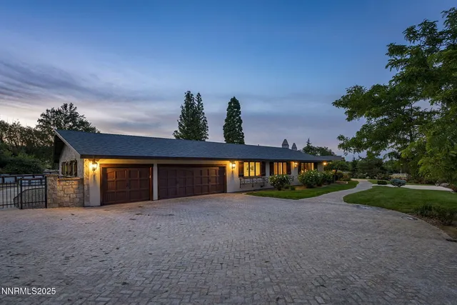 a living room with furniture a fireplace and a large window