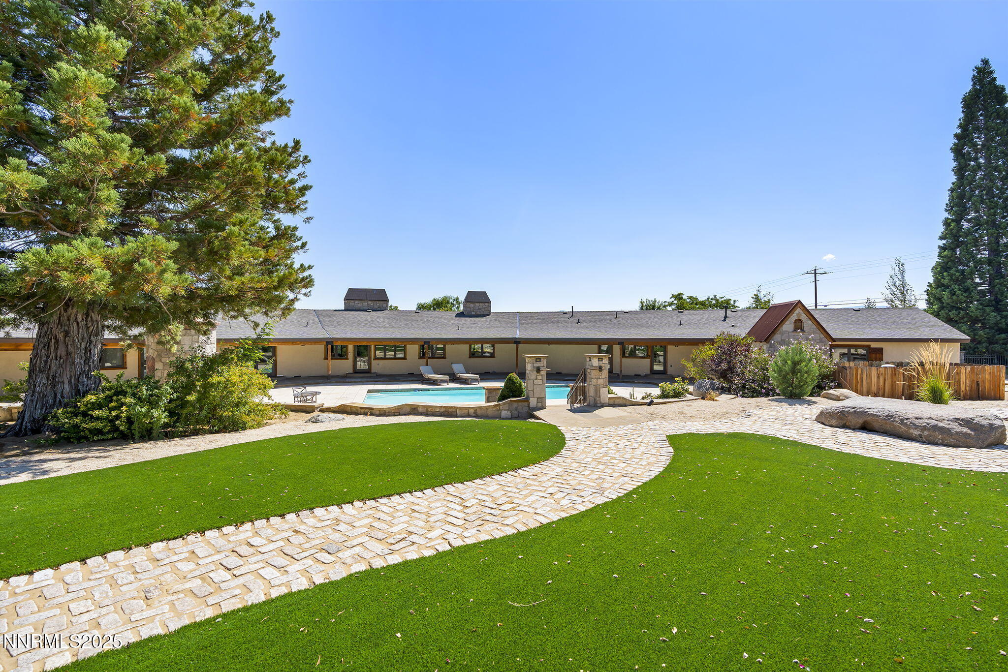 3405 Lone Tree Lane Reno, NV 89511 - Photo 61 of 80 a view of a swimming pool with lawn chairs and a big yard